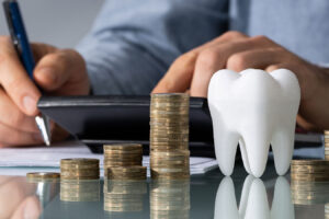 a tooth model and stacks of coins