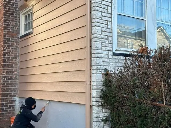 a person painting a house