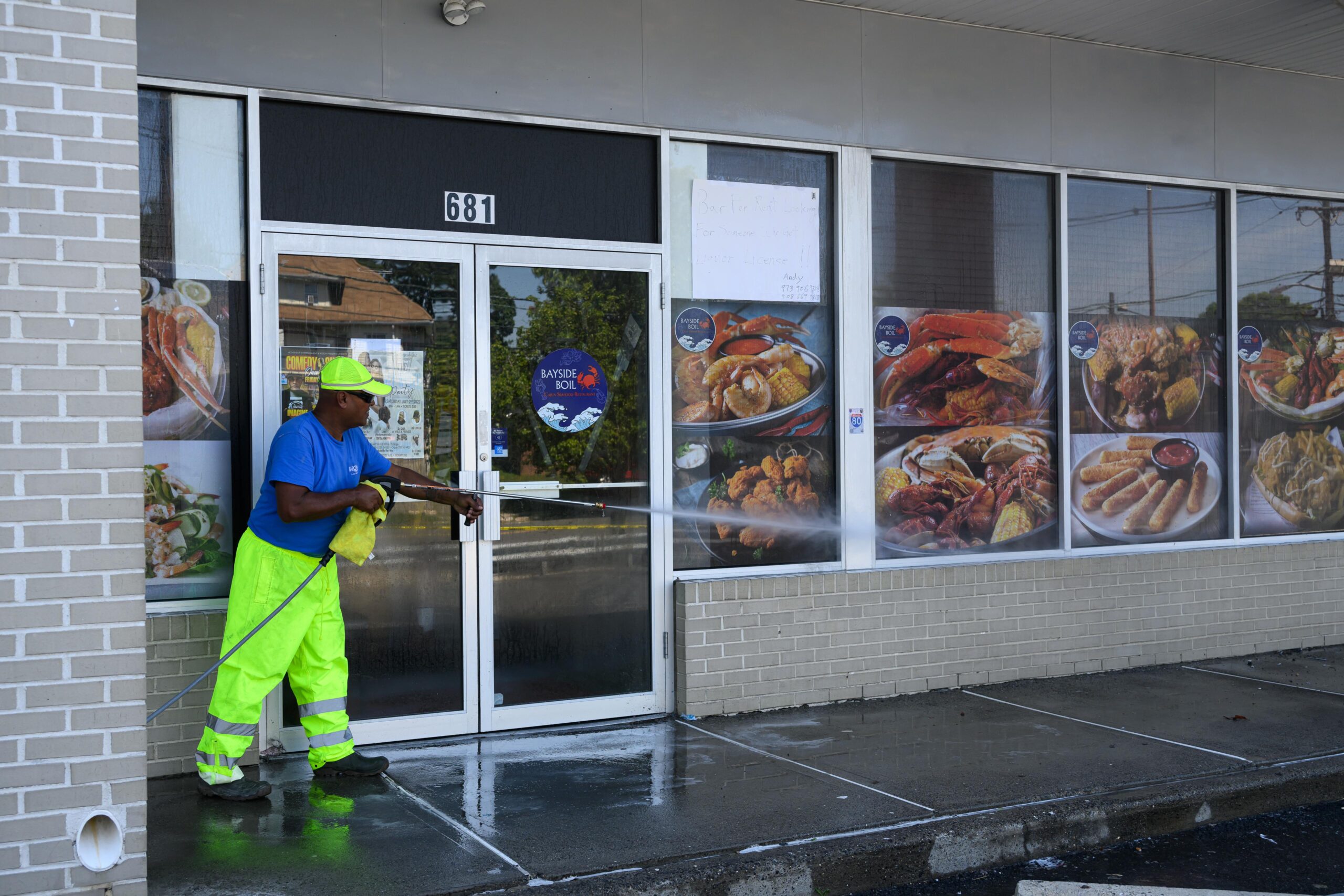 a man spraying water on a building