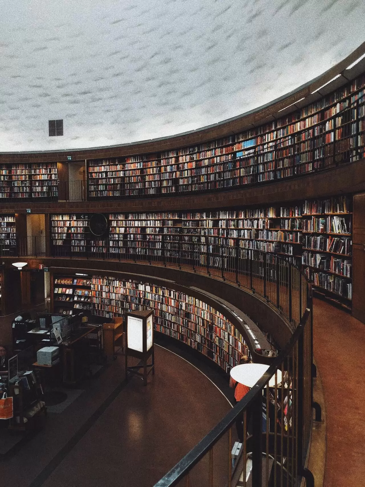 a circular library with many books on the wall