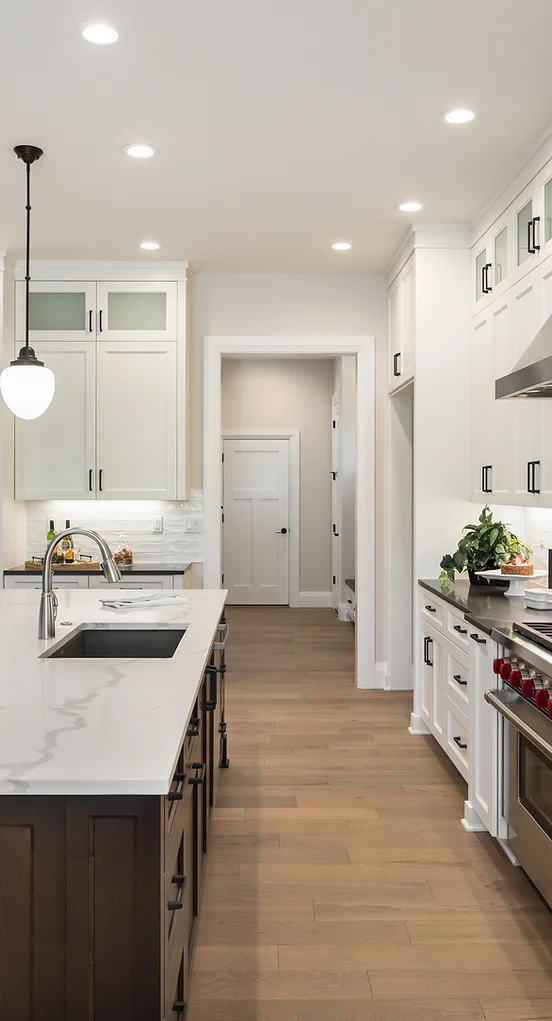 a kitchen with white cabinets and a white countertop