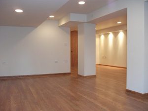 a room with a wood floor and a wooden door