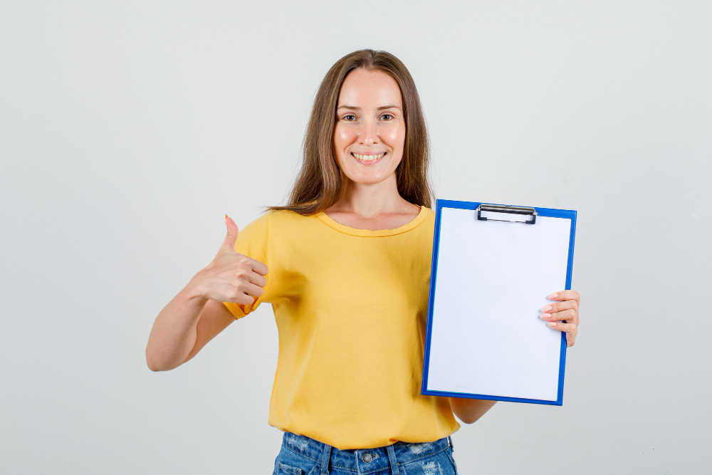 a woman holding a clipboard and giving a thumbs up