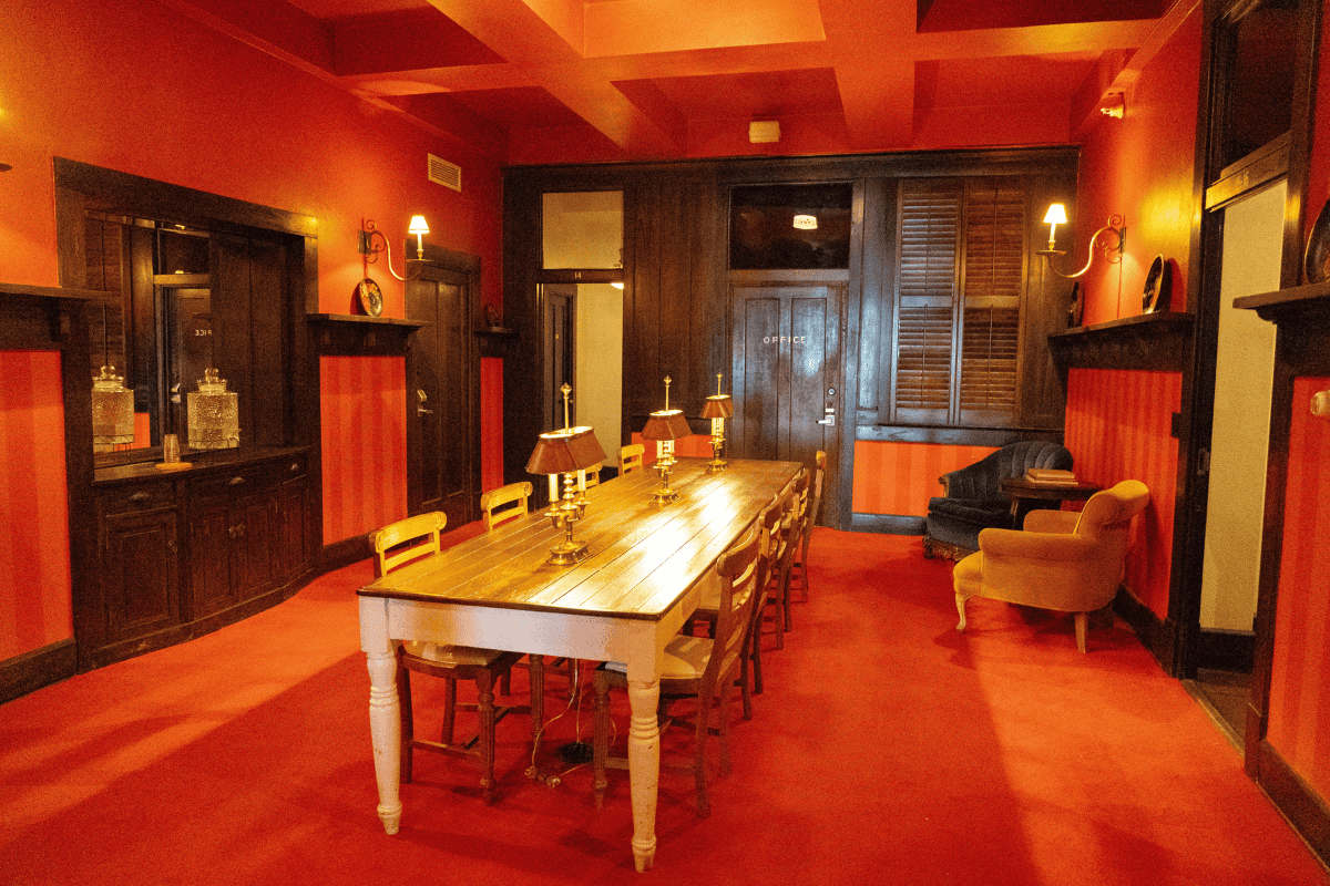 a room with a long table and chairs