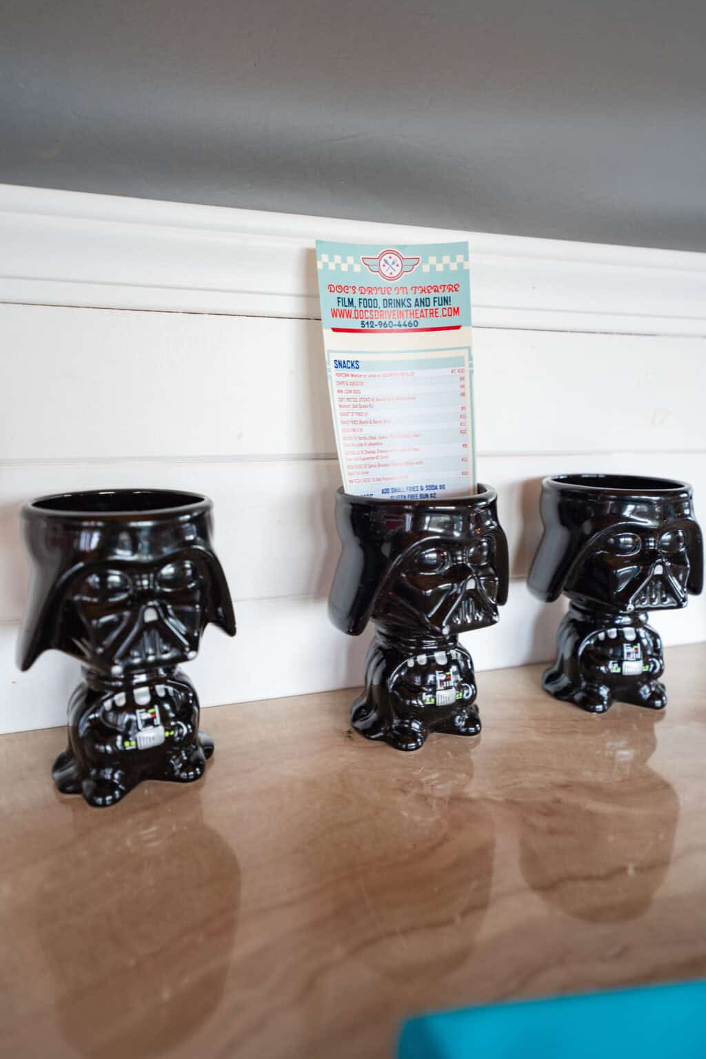 a group of black mugs with a menu