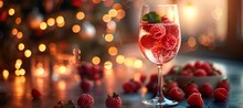 a glass of raspberries and a christmas tree