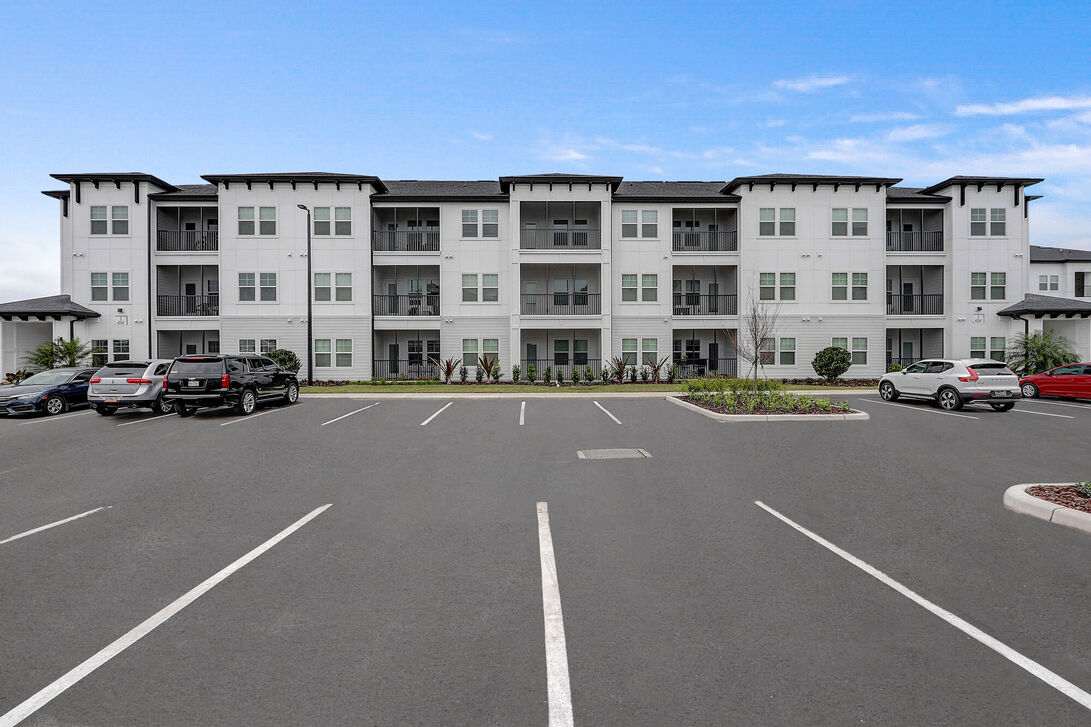 a parking lot with cars and a building