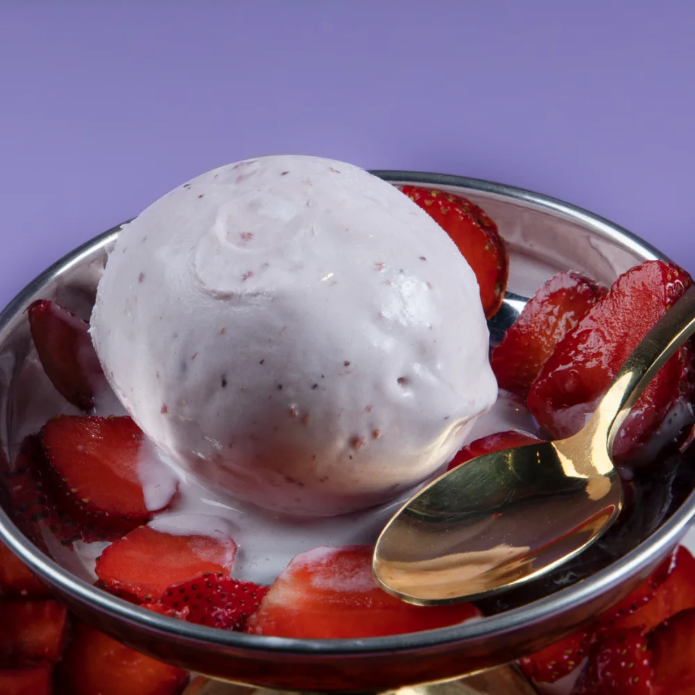 a bowl of ice cream with strawberries