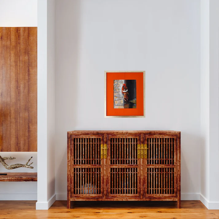 a wooden cabinet with a painting on the wall