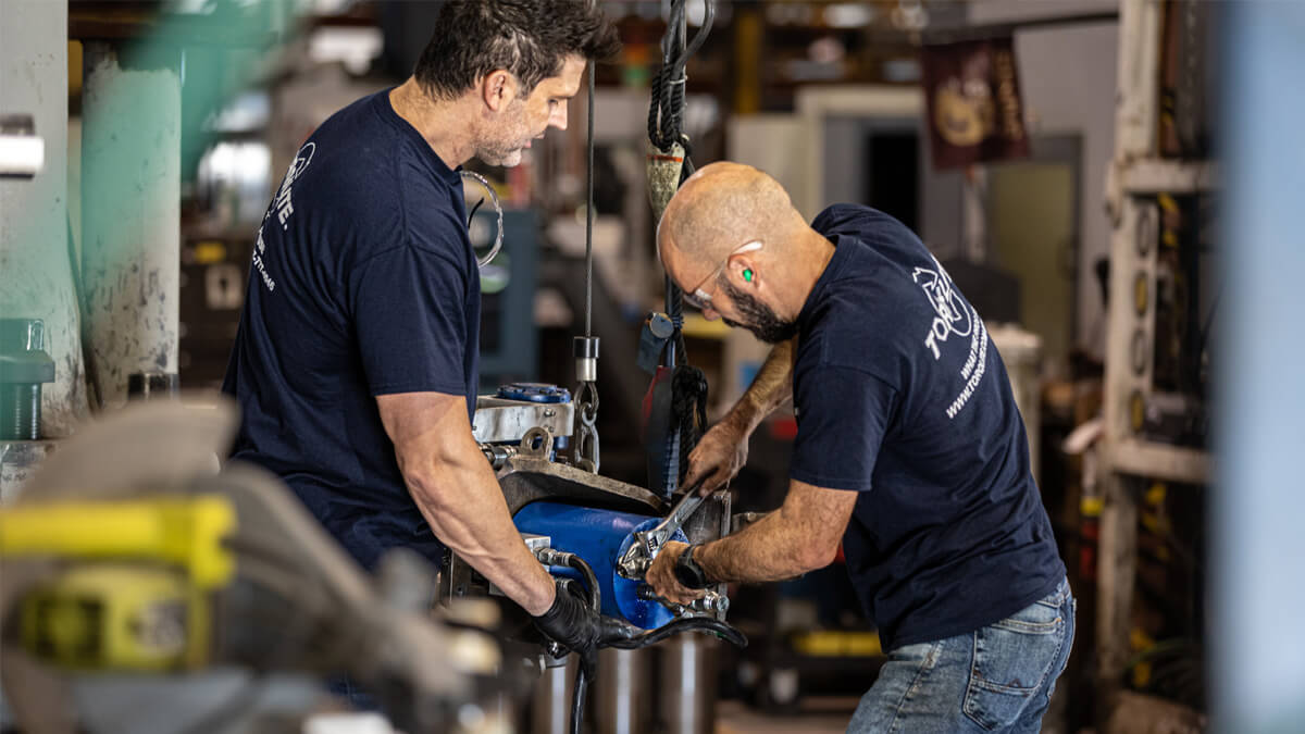 two men working on a machine