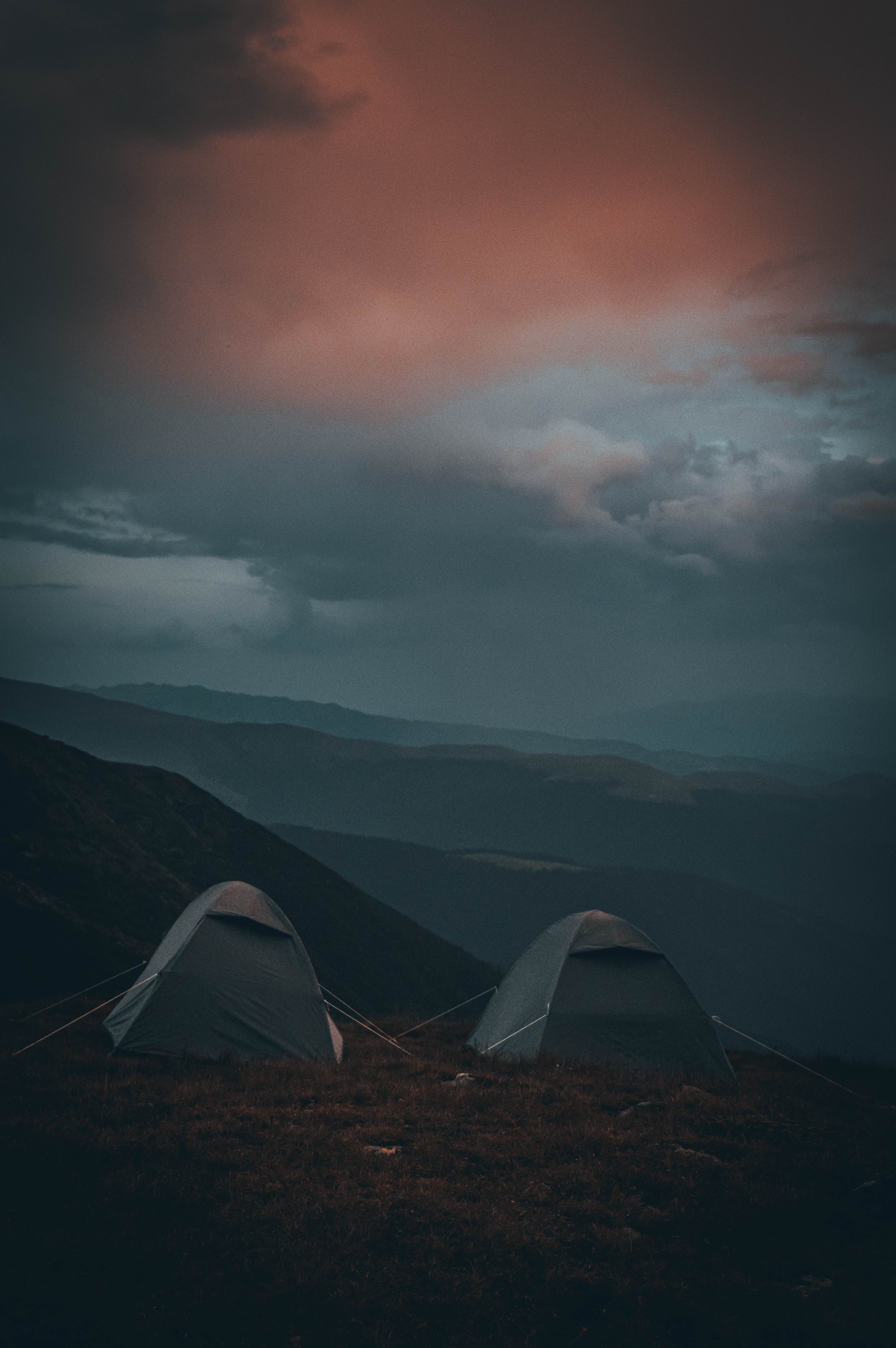 two tents on a hill