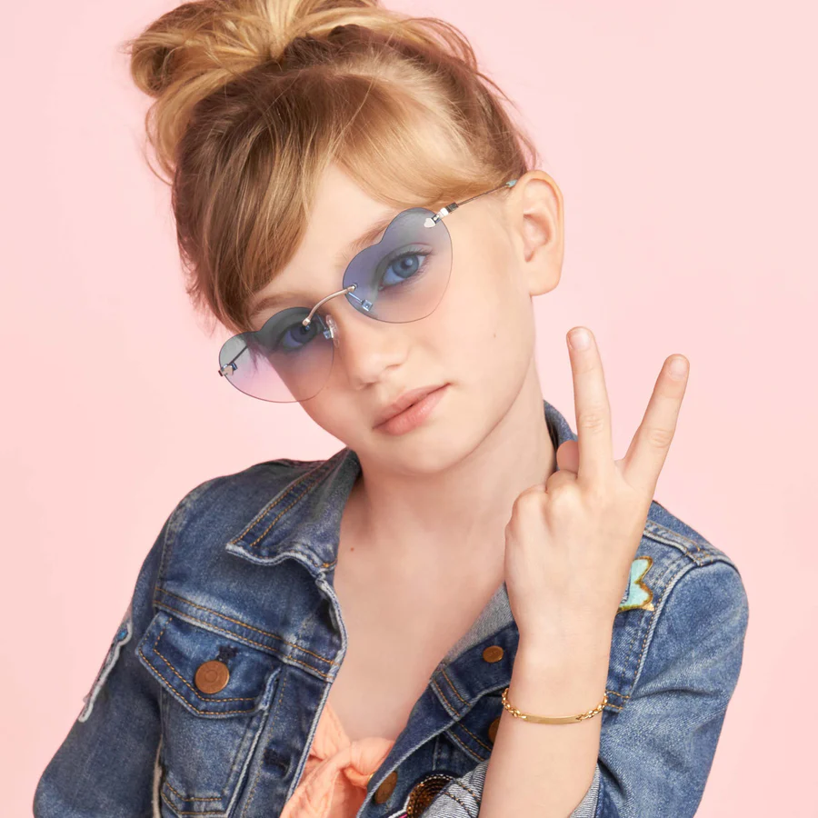 a girl wearing sunglasses and a denim jacket