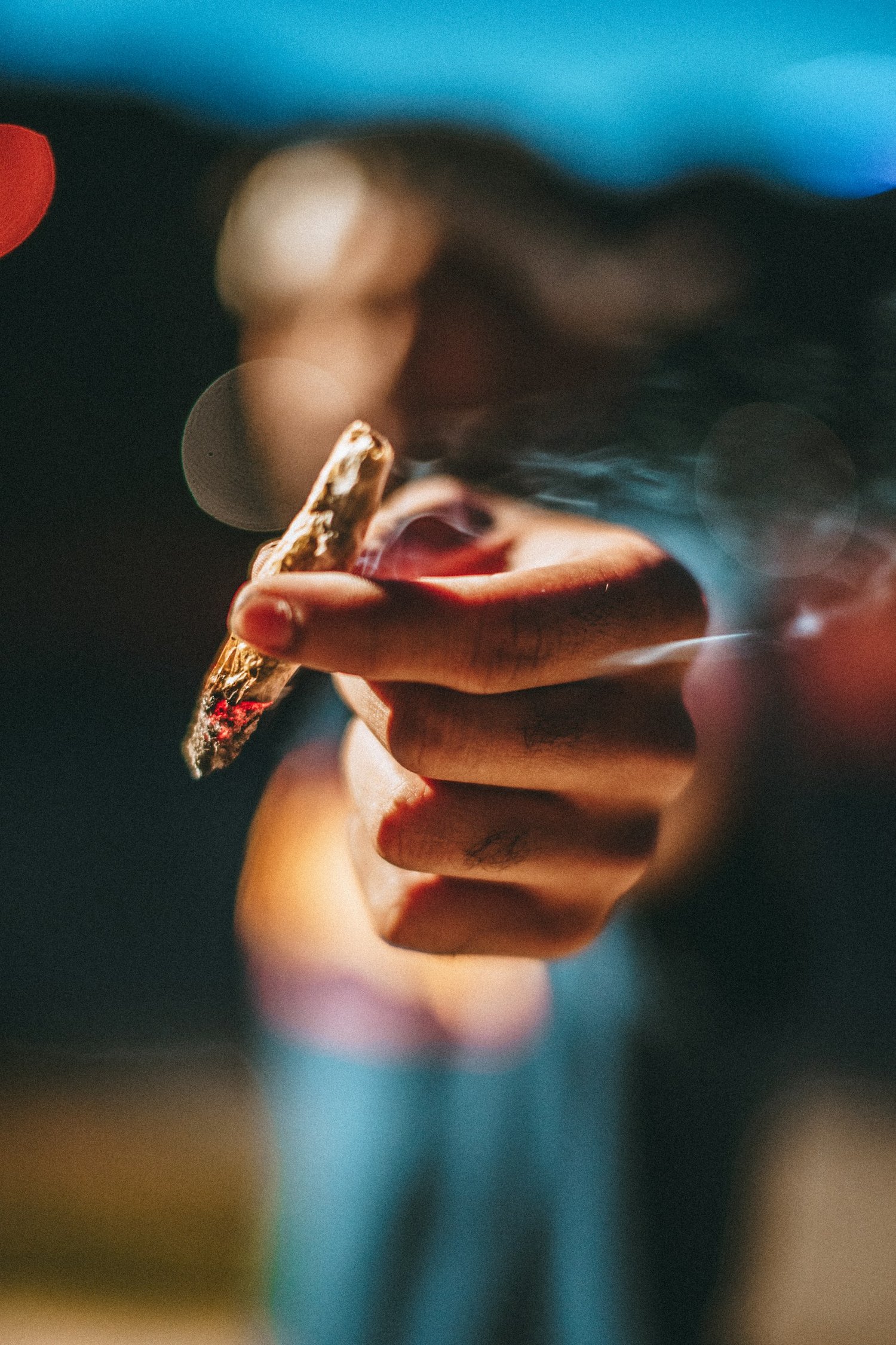 a hand holding a piece of marijuana