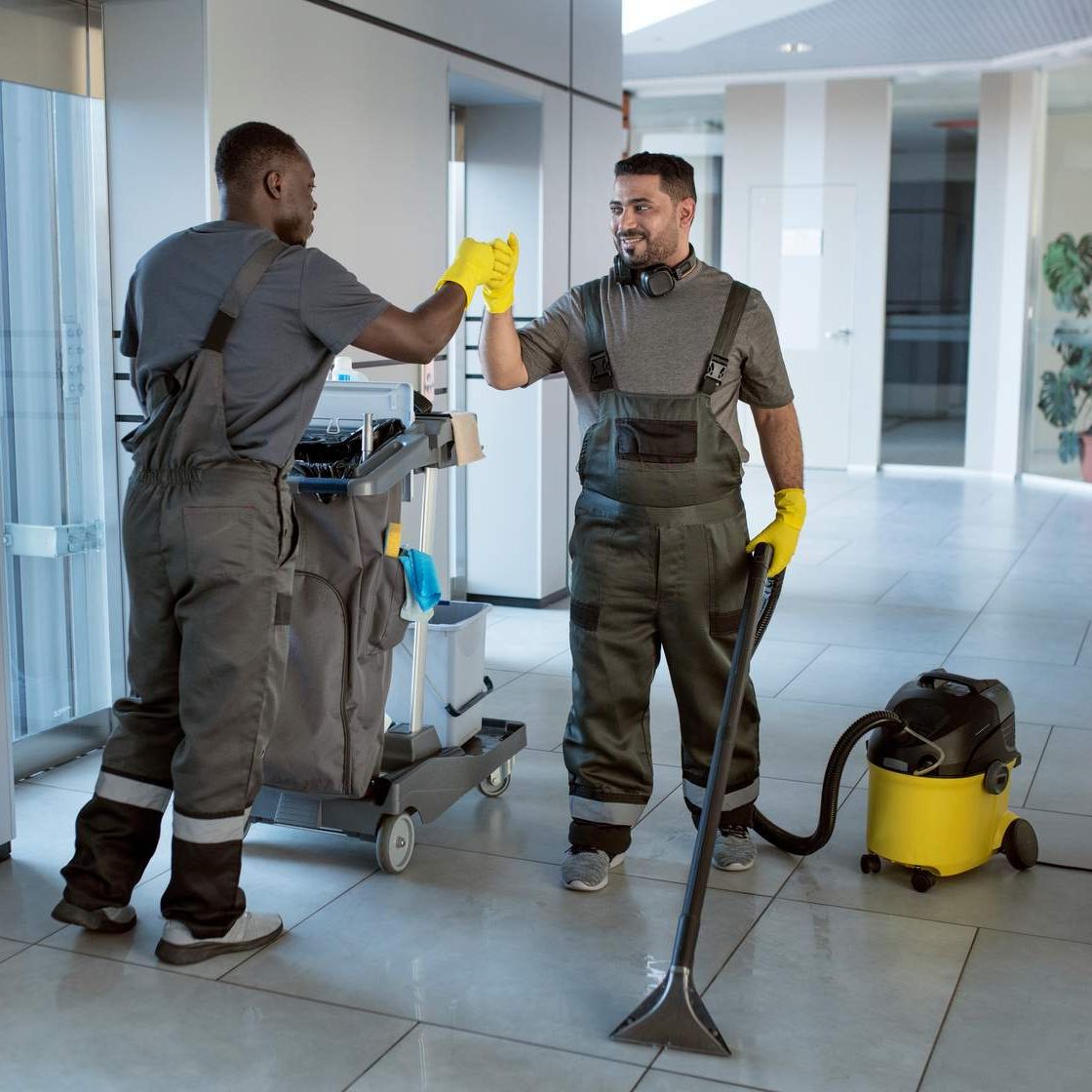 a man in a uniform with a vacuum cleaner