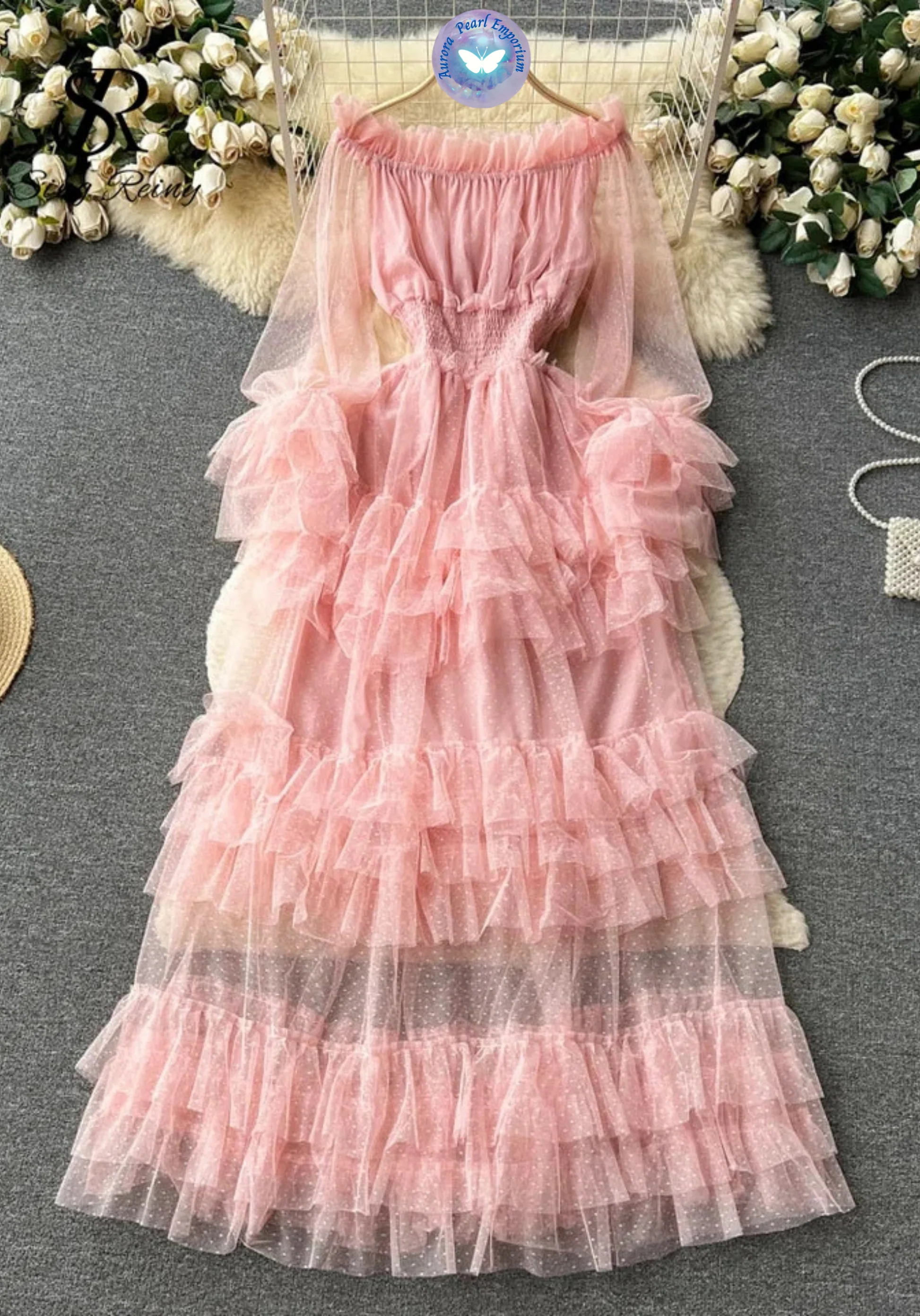 a pink dress on a white fur rug