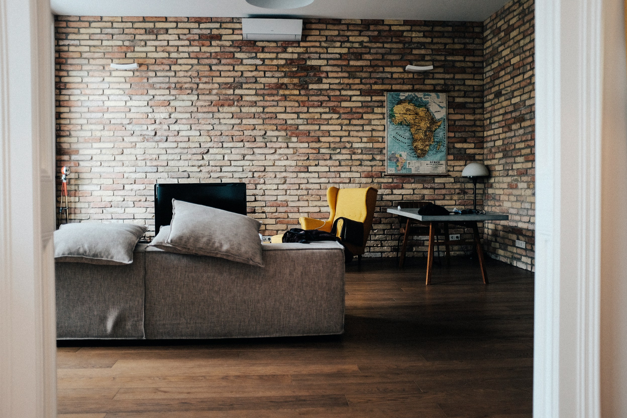 a room with a brick wall and a couch