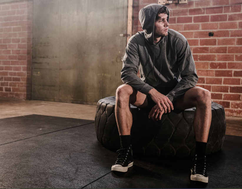 a man sitting on a tire