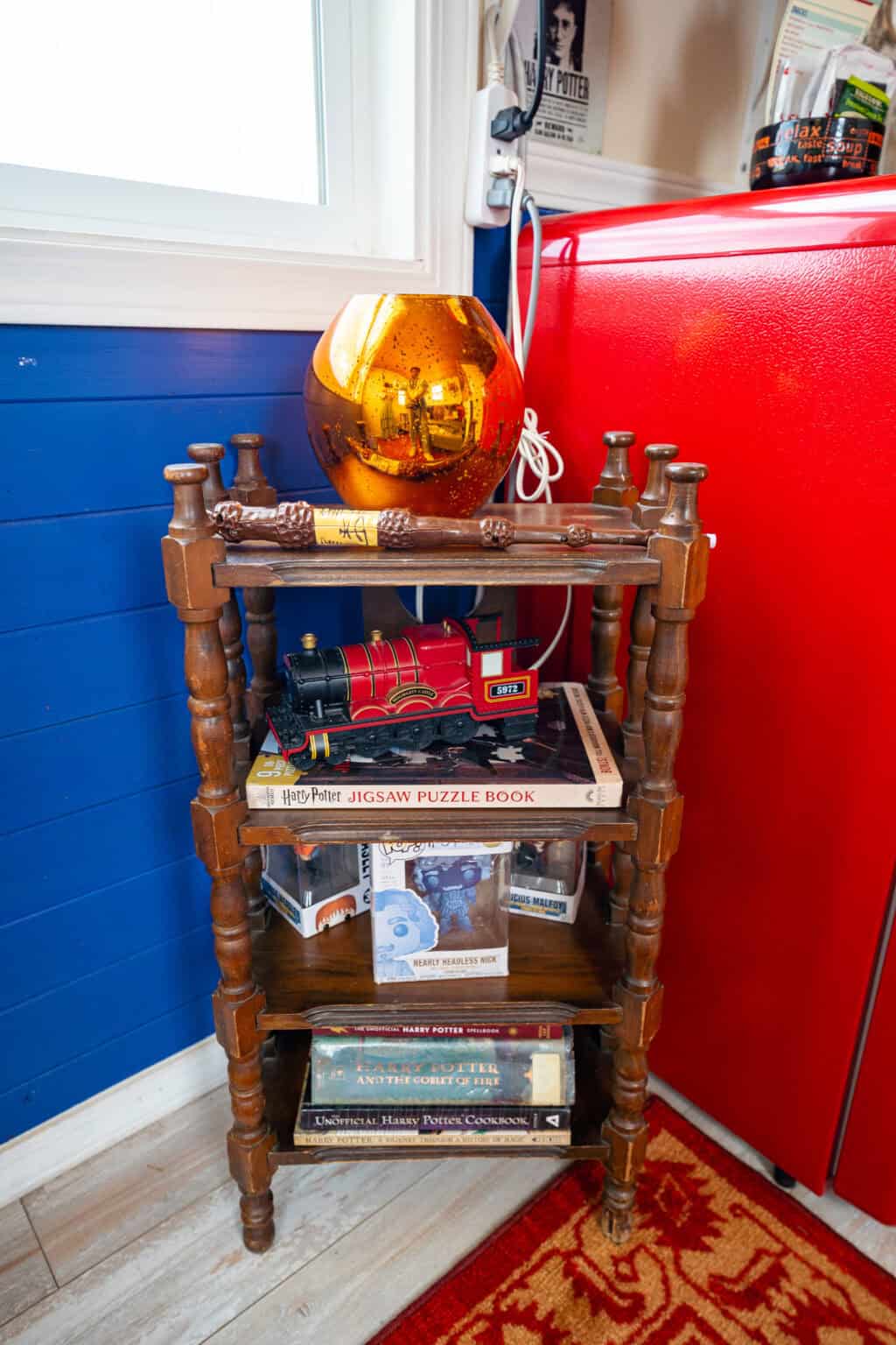 a shelf with books and a ball on top