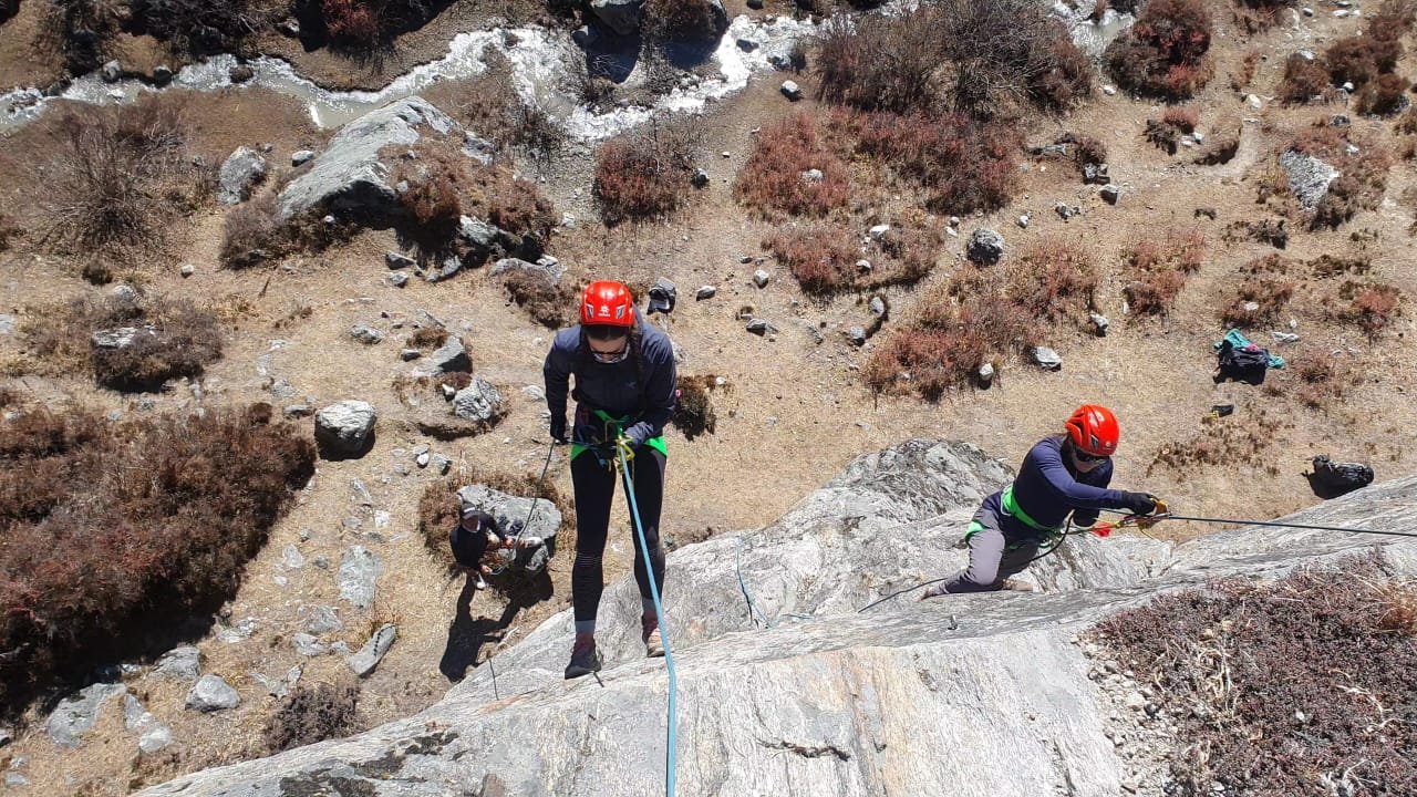 a group of people climbing a rock