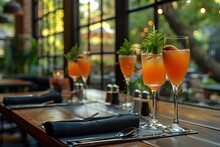 a group of glasses with orange liquid on a table