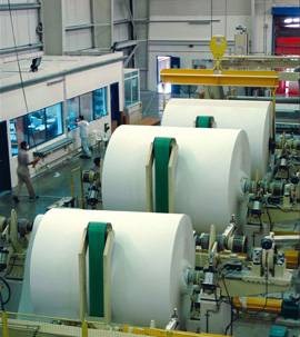 a large rolls of paper in a factory
