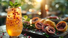 a glass of orange drink with a fruit on a tray