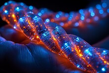 a hand holding a string of glowing lights