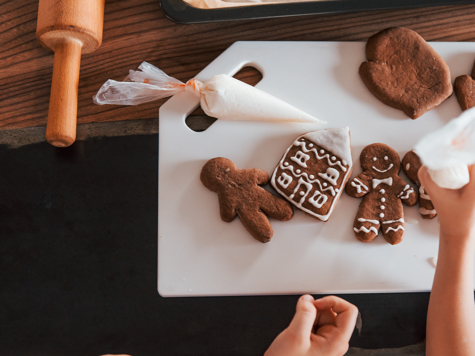 a person decorating gingerbread cookies