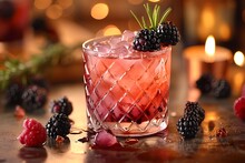 a glass of drink with berries on a table