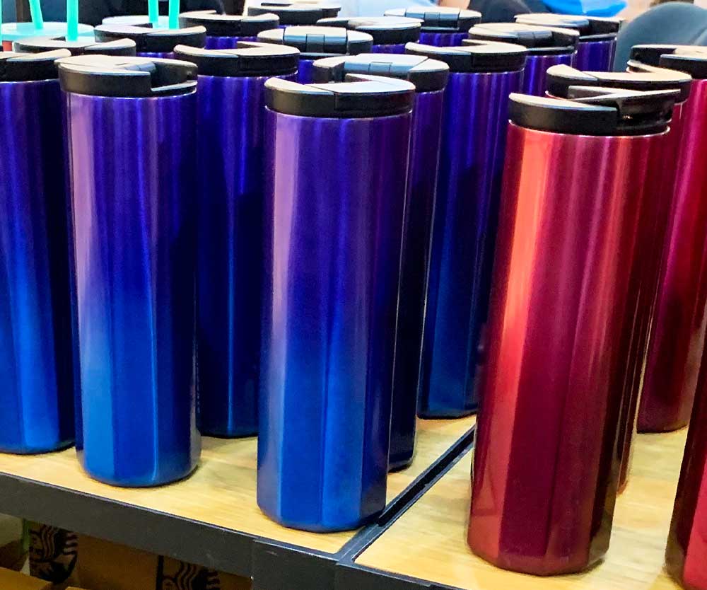 a group of blue and red tumblers on a shelf