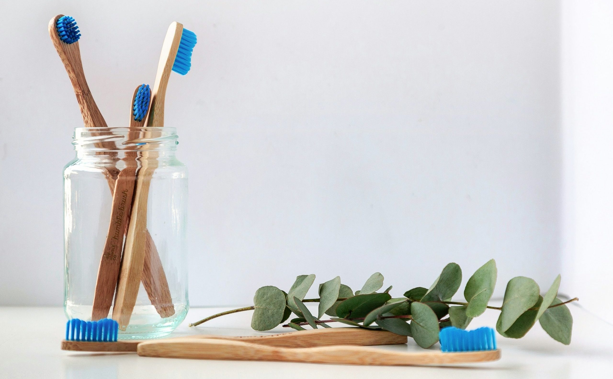 a group of wooden toothbrushes in a jar