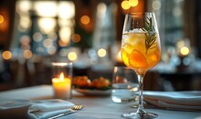 a glass of orange liquid on a table