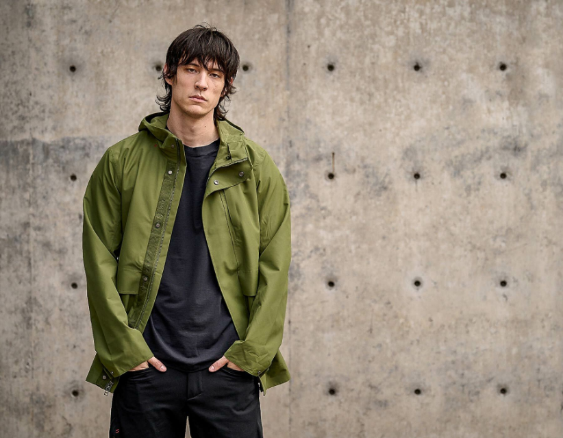 a man standing in front of a concrete wall