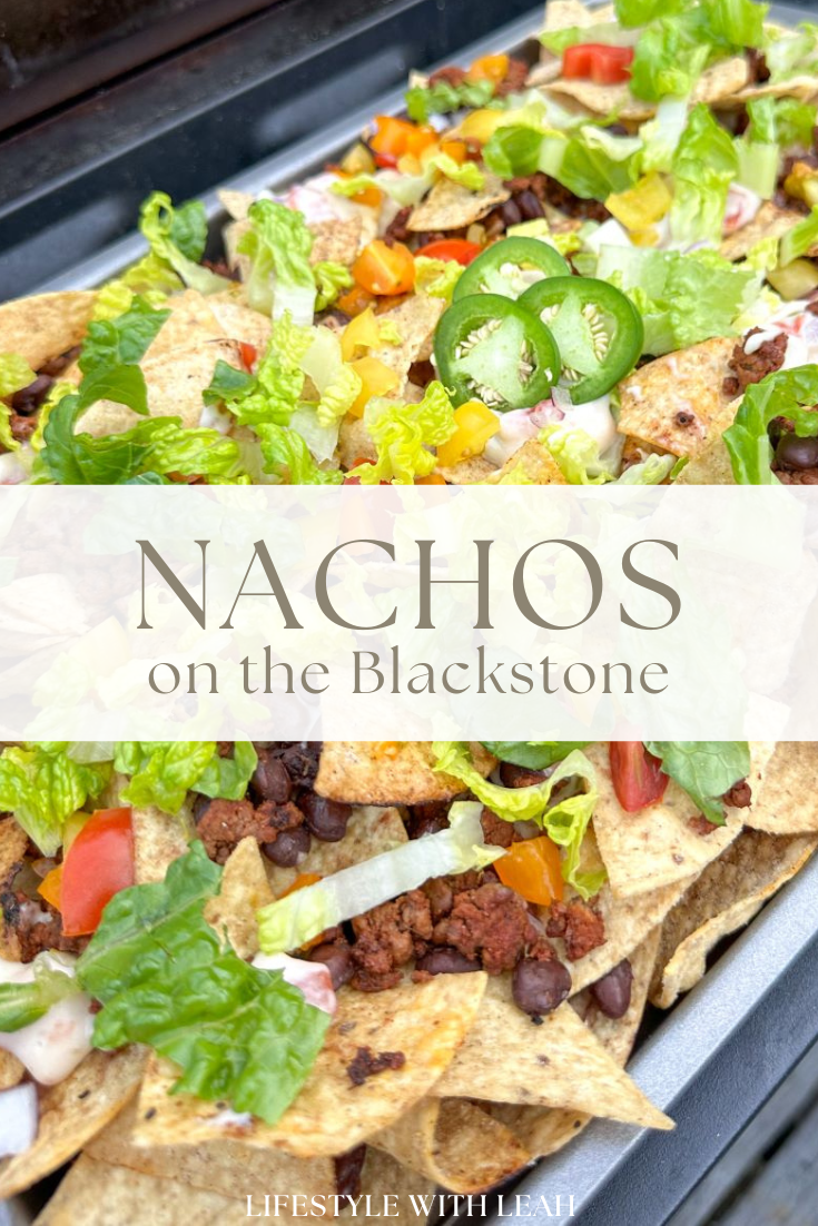 a tray of nachos with vegetables and meat