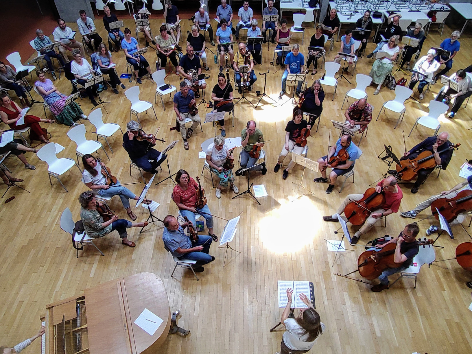 a group of people sitting in chairs and playing instruments