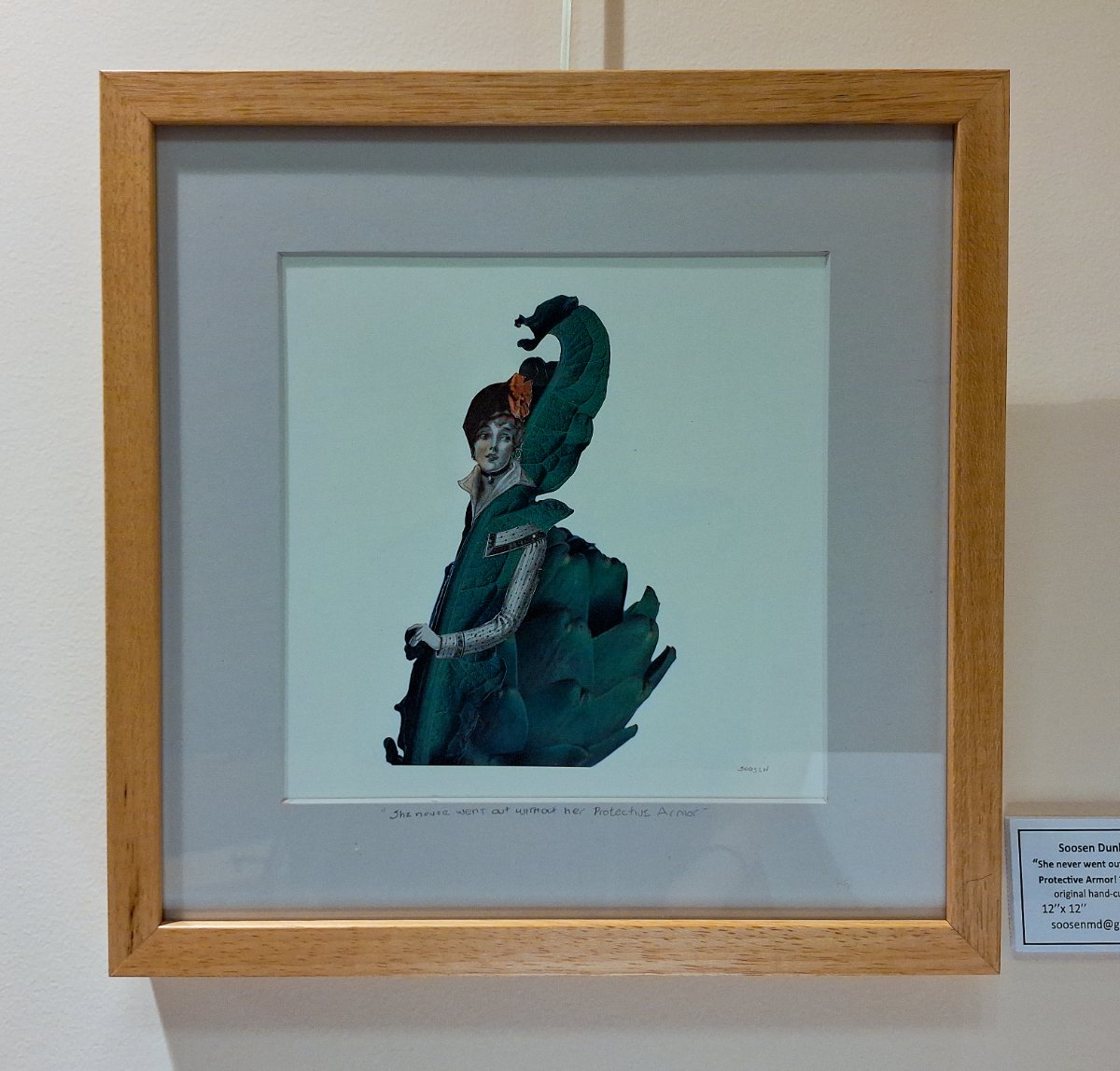 a framed picture of a woman in a garment