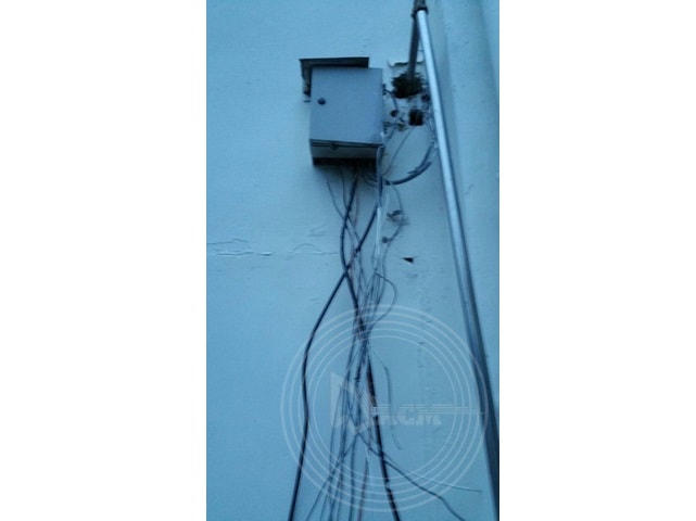 a box with wires on the side of a wall