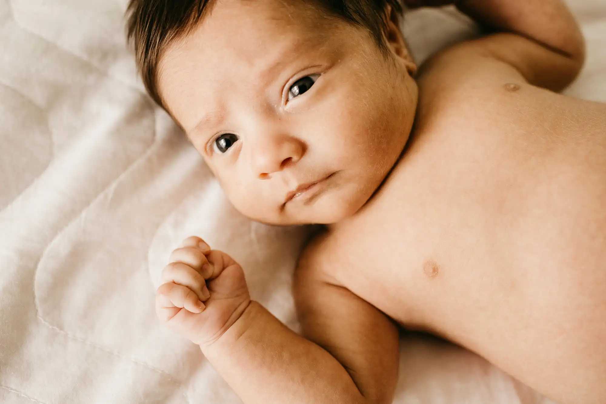 a baby lying on a blanket