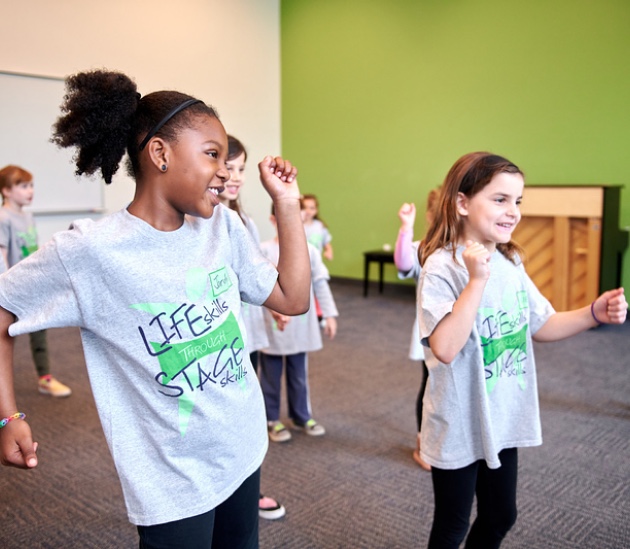 a group of children dancing in a room