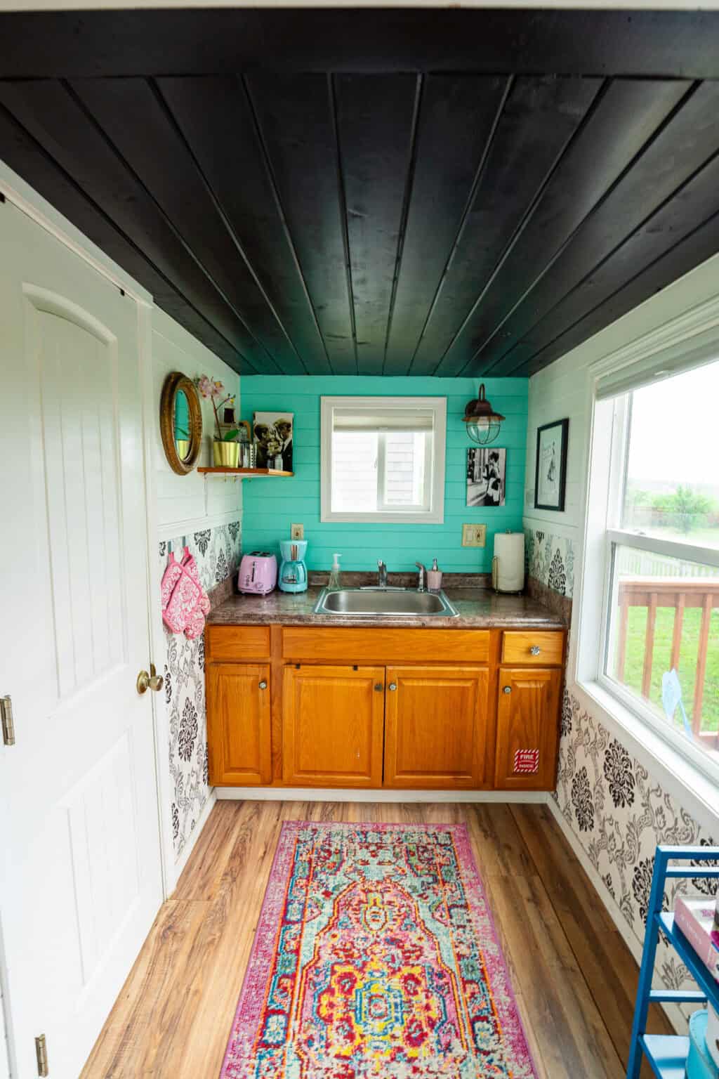 a kitchen with a sink and a rug
