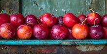 a group of red apples on a blue tray