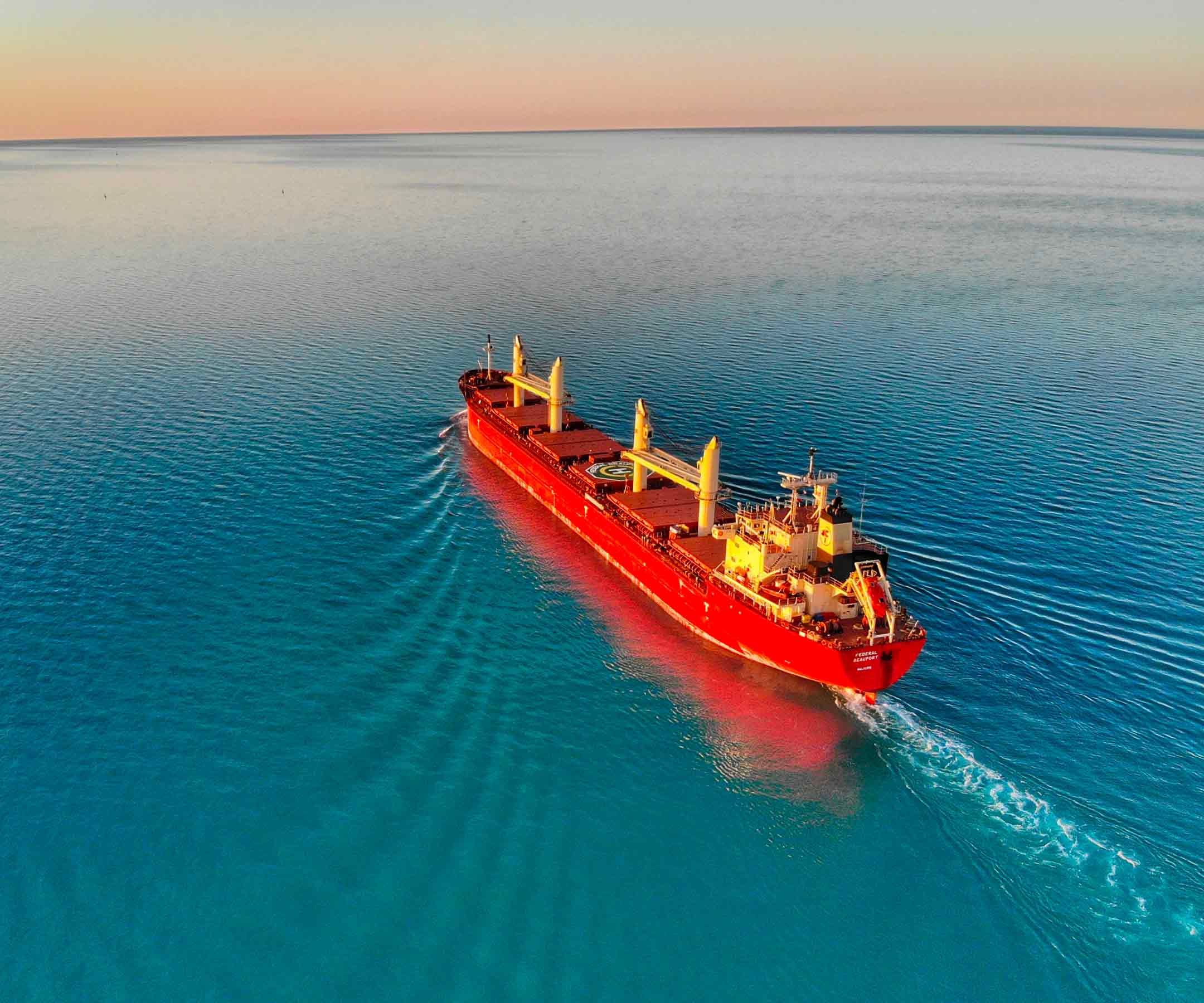 a large red ship in the ocean