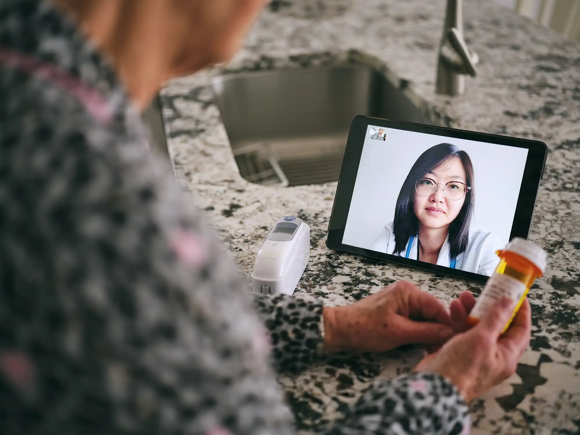 a woman using a tablet to talk to a doctor