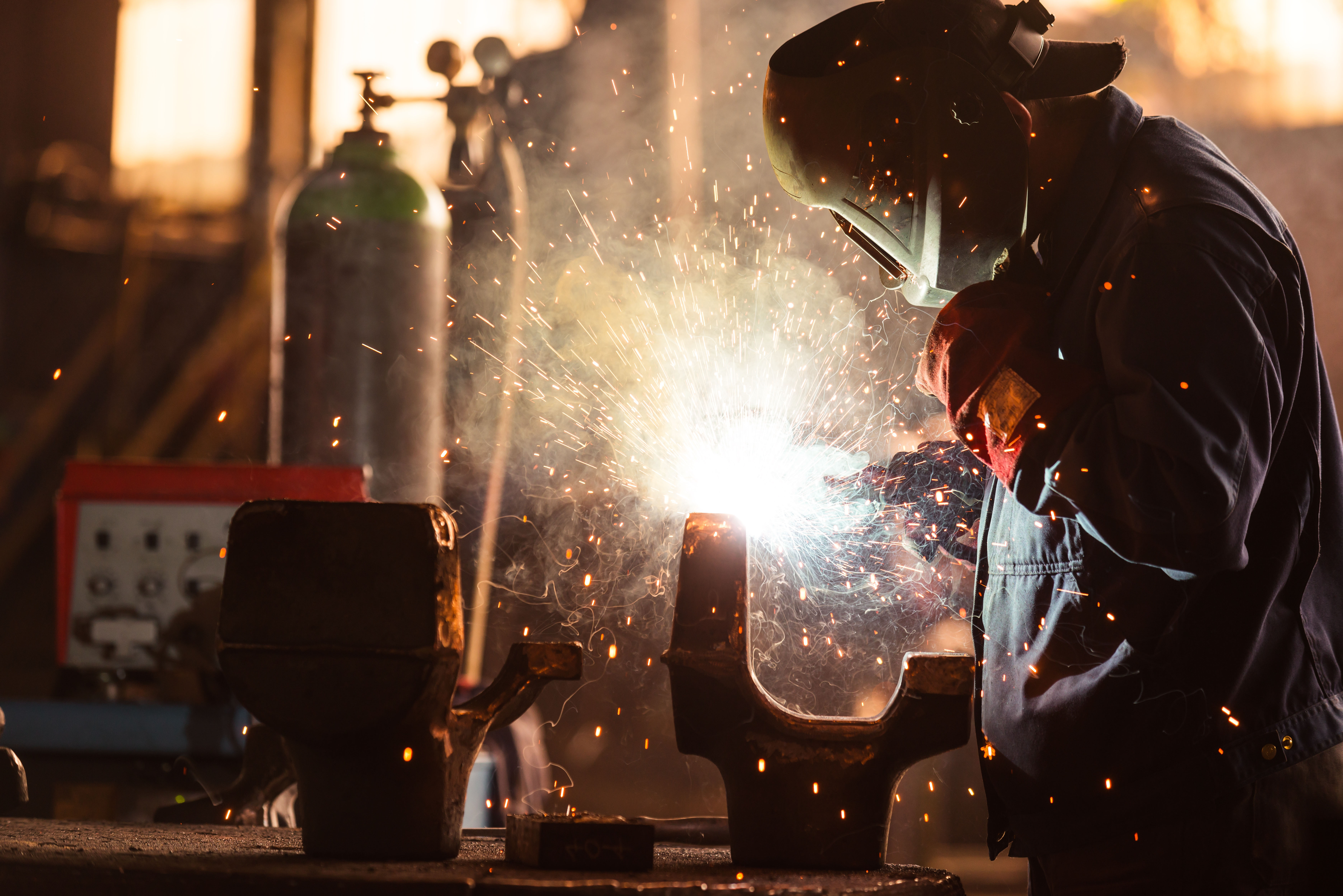 a man welding with sparks