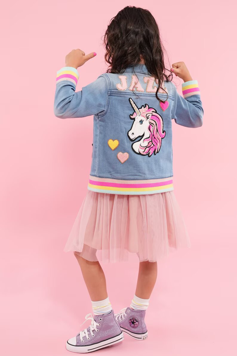 a girl in a pink tutu and a denim jacket