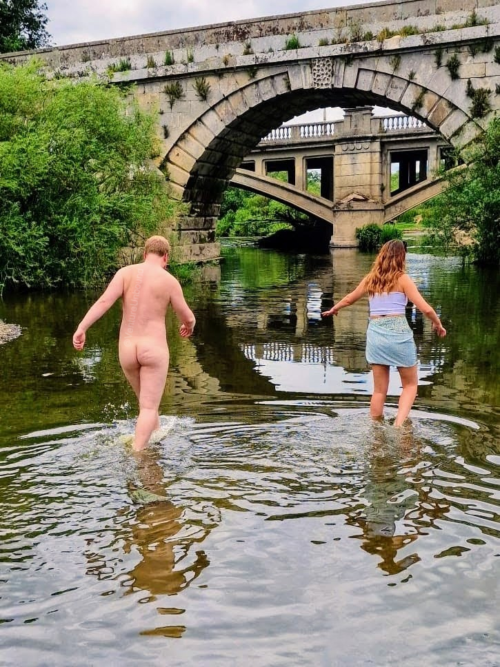 a man and woman walking in water