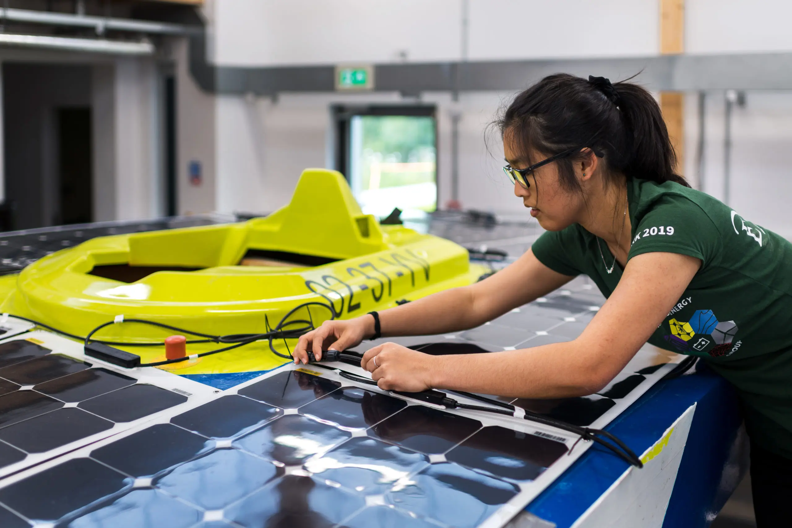 a woman working on a solar panel