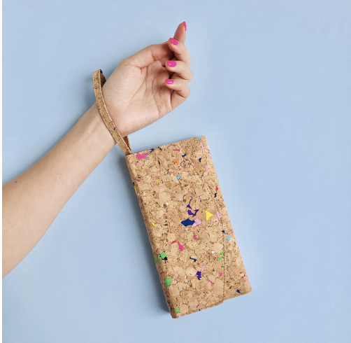 a hand holding a cork purse