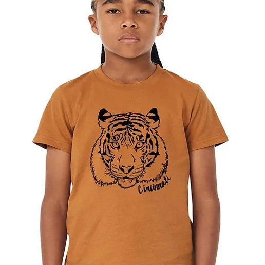 a girl with braids wearing a t-shirt with a tiger on it