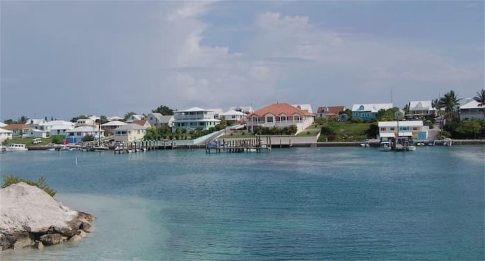 a body of water with houses and a dock